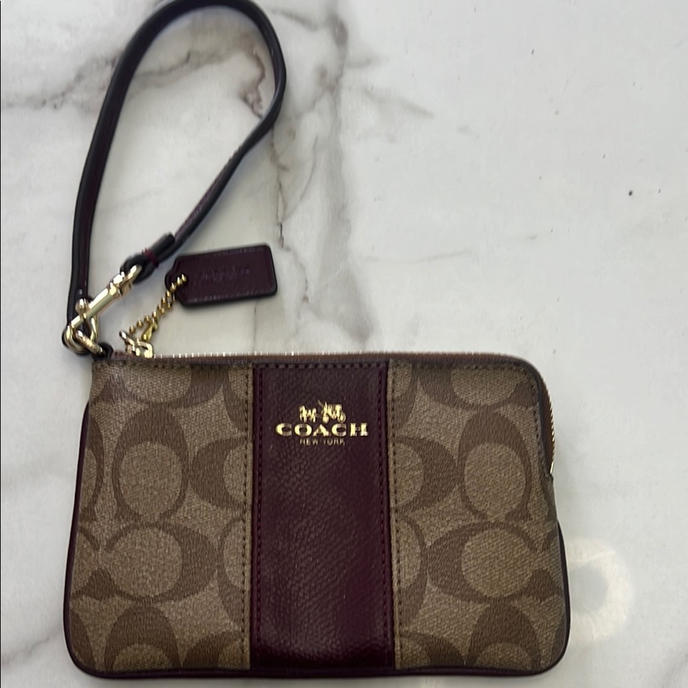 - Coach Brown Signature Wristlet with Gold Accents